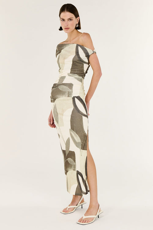 Woman wearing a patterned off-shoulder dress on a white background