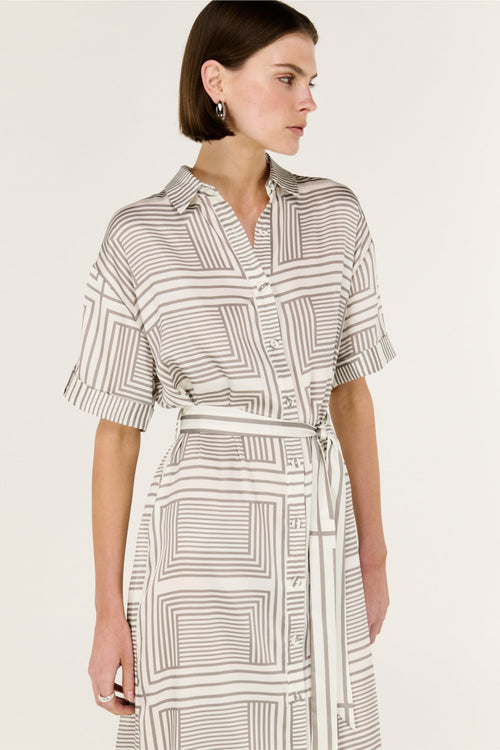 Woman wearing a patterned dress on a white background