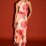 Woman wearing a floral dress against a red background