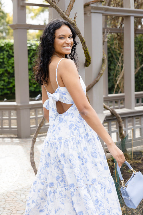 model posing in floral blue long dress