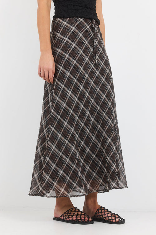 Person wearing a plaid skirt on a white background