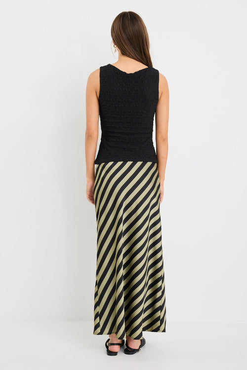 model wearing a silky green black stripe skirt