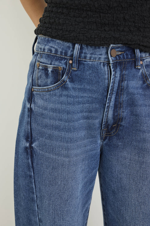 Close-up of blue jeans with a plain background