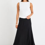 Woman wearing a black skirt and white top