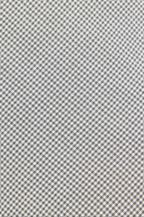 Textured fabric pattern with a subtle checkered design.