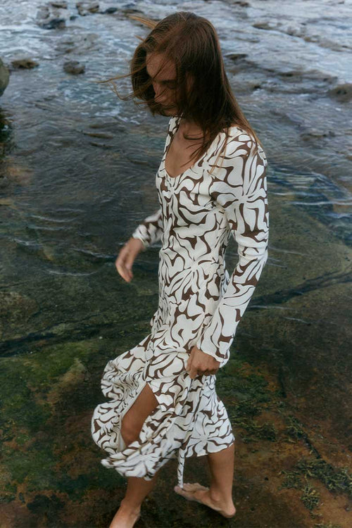 model wears a brown floral long sleeve dress