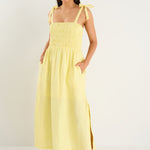 model wears a yellow strappy midi dress