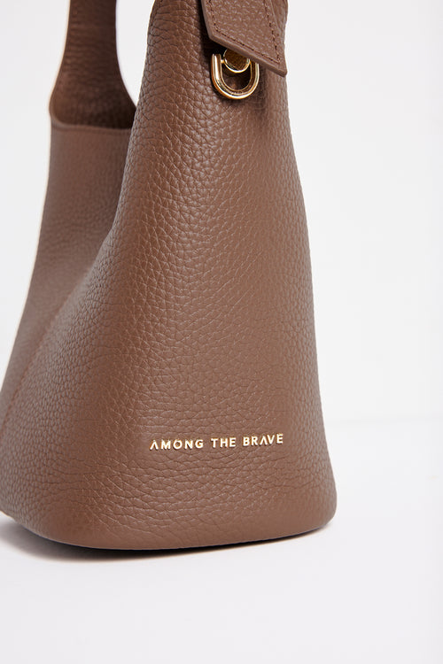 Valencia Brown Leather Multi Strap Mini Tote Bag in a structured bucket silhouette featuring pebbled brown leather, an adjustable shoulder strap and gold hardware, photographed against a clean white background