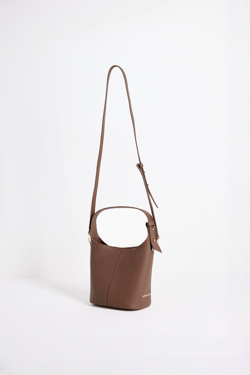 Valencia Brown Leather Multi Strap Mini Tote Bag in a structured bucket silhouette featuring pebbled brown leather, an adjustable shoulder strap and gold hardware, photographed against a clean white background