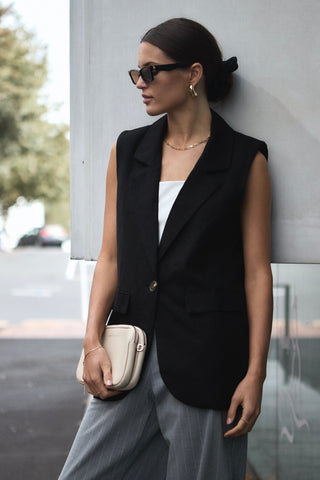 model wears a black vest