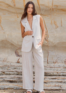 model wears a beige linen vest