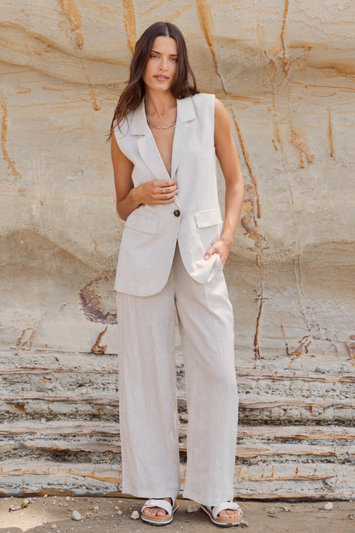 model wears a beige linen vest