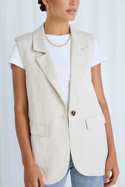 model wears a beige linen vest