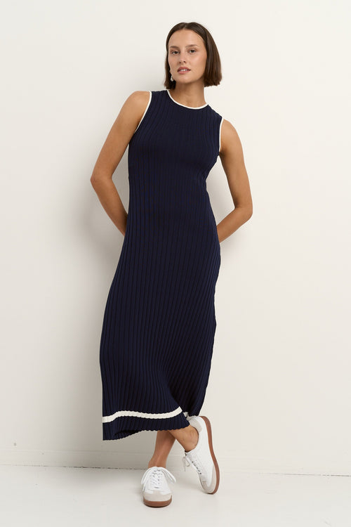 model wearing a navy knit dress