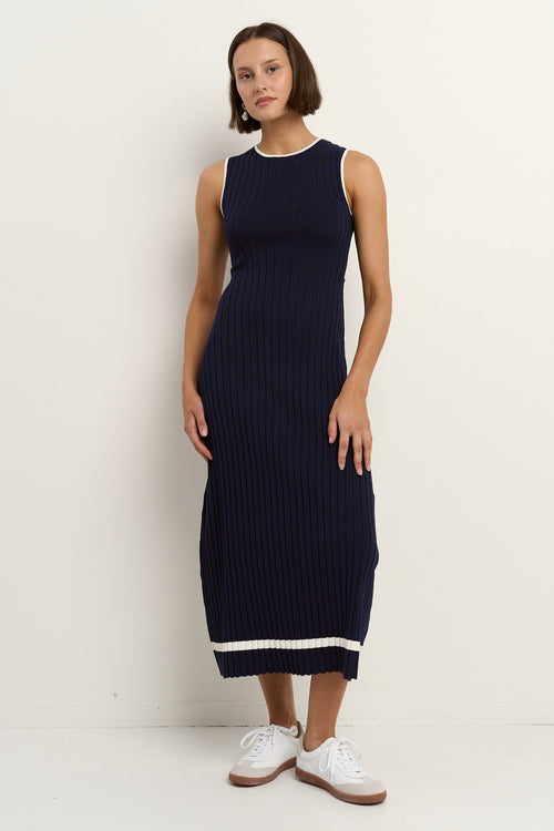 model wearing a navy knit dress