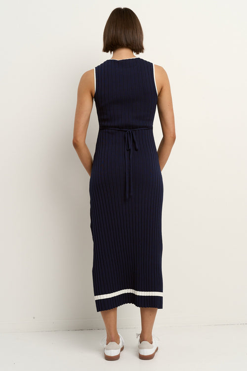 model wearing a navy knit dress