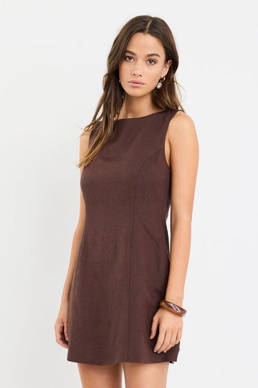 Woman wearing a brown dress on a white background