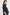 model wears a navy blue blouse with dark blue jeans
