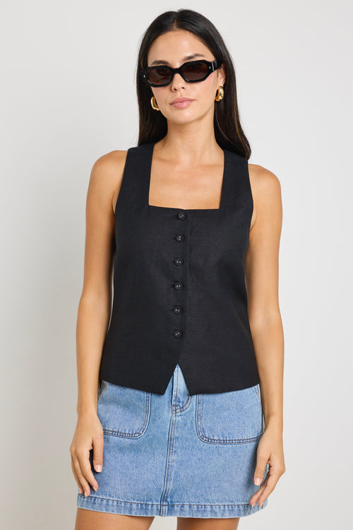 model wears a black linen vest