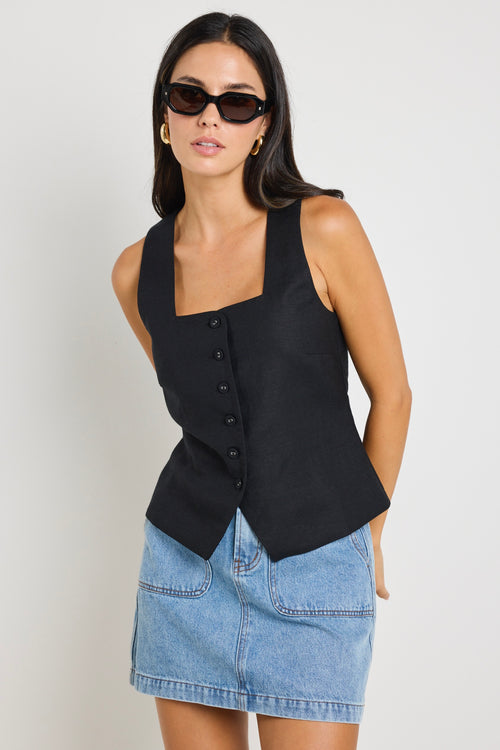 model wears a black linen vest