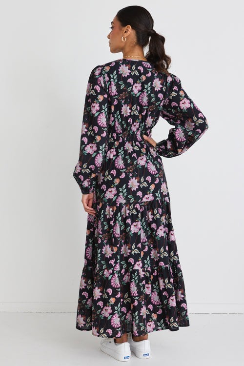 model wears a black floral maxi dress