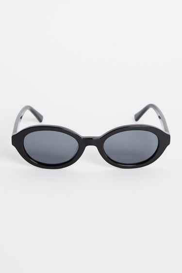 Black oval sunglasses with dark tinted lenses and a glossy frame, photographed against a white background