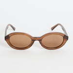 Espresso-brown oval sunglasses with tinted lenses and slim arms featuring RE:UNION label branding, photographed on a white background