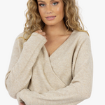 model wearing oat long sleeve v neck jumper