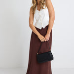 model wears a brown linen maxi skirt