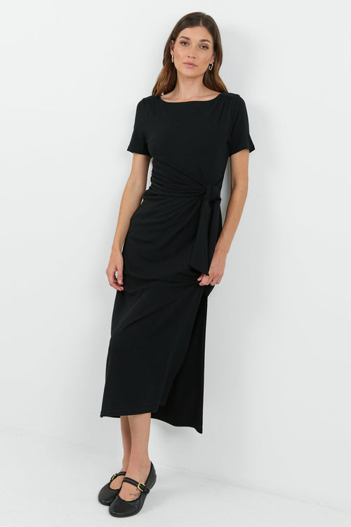 This black dress features a flattering side tie detail and a relaxed fit, perfect for both casual and dressy occasions.