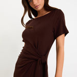 Model wearing a chocolate brown short sleeve jersey maxi dress with a waist tie and side split