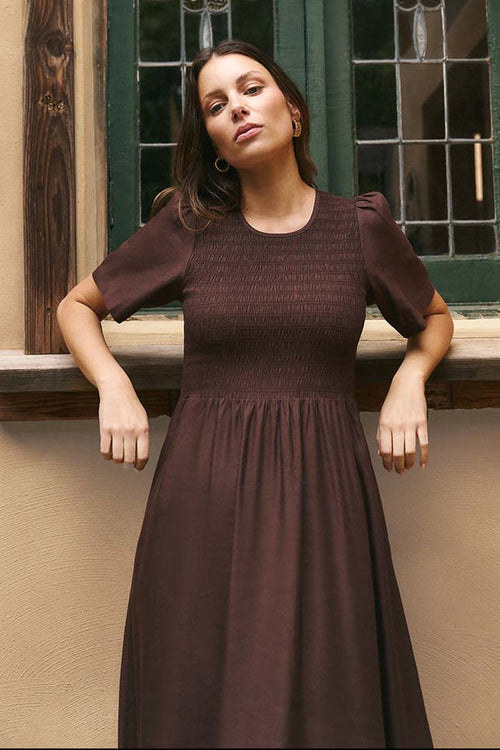 Woman wears a chocolate brown dress