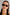 Front-facing view of oval sunglasses in a glossy dark tortoiseshell frame with smoke-tinted polarised lenses. The compact, rounded silhouette nods to 90s retro styling, offering a bold yet wearable look.