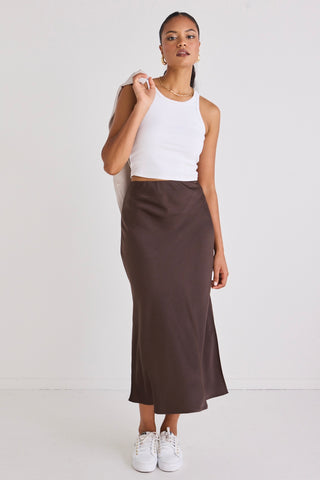 model wears a brown midi skirt