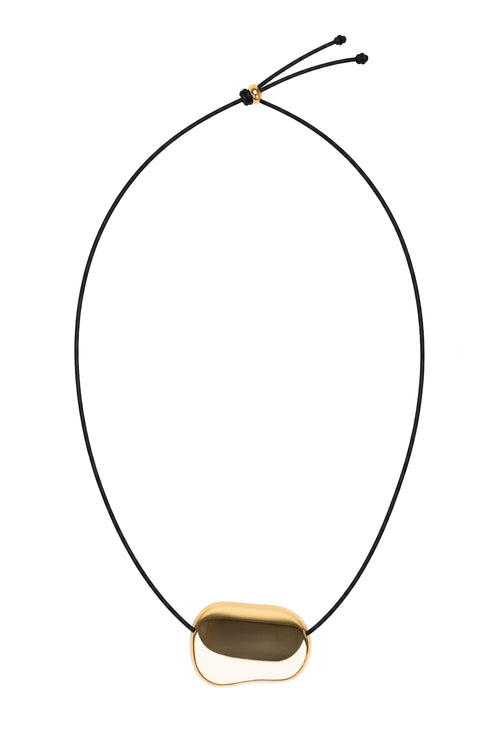 A minimalist adjustable cord necklace featuring a smooth, organic-shaped gold pendant with a dark brown center, displayed on a clean white background.