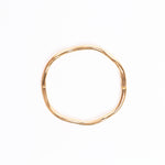 Gold bangle on a white background