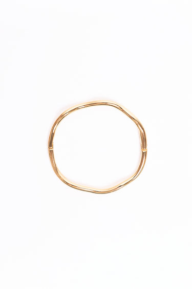 Gold bangle on a white background