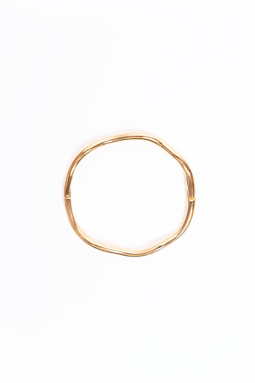 Gold bangle on a white background