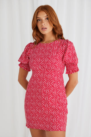 model in red spotty mini dress