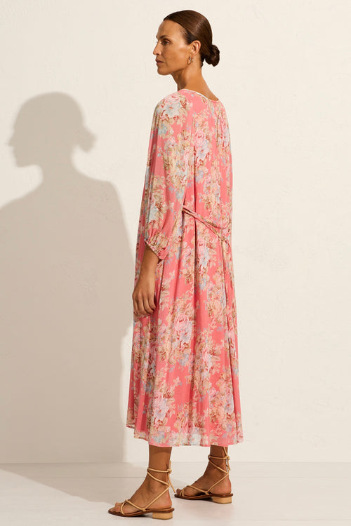 model wears a pink floral midi dress