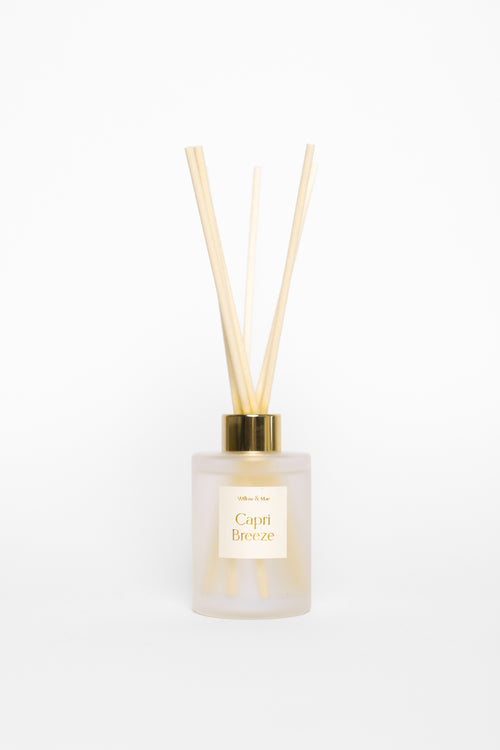Diffuser bottle with wooden sticks on a white background