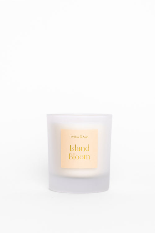 Candle labeled 'Island Bloom' with a white background