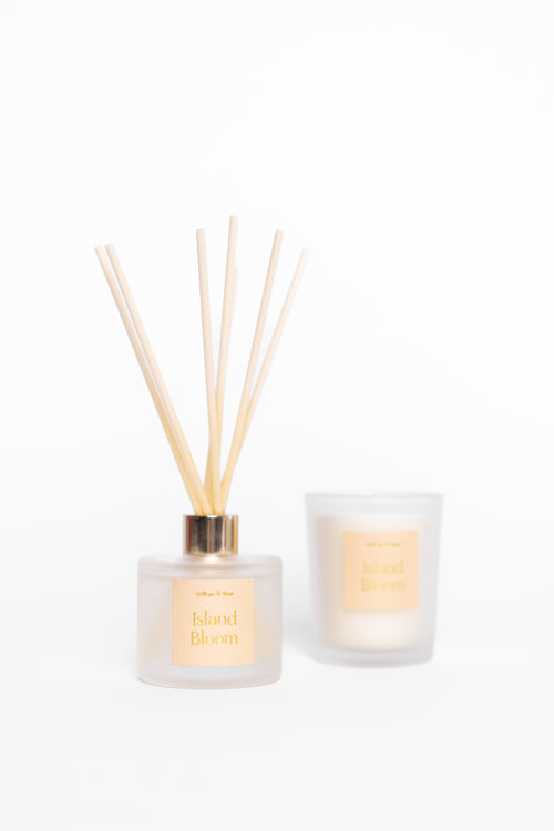 Diffuser with reeds and candle on a white background