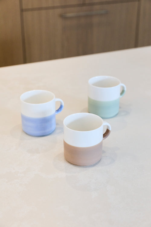 Artist Stone hand painted two tone stackable mug shown alongside blue and sage green colourways for styling reference; listing is for the stone mug only.