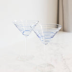 Fiesta Blue Swirl Stripe Martini Glass in clear glass with delicate blue spiral detailing, styled on a light marble surface.