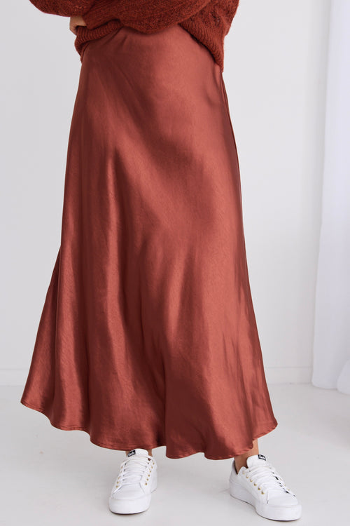 model wears a red midi skirt
