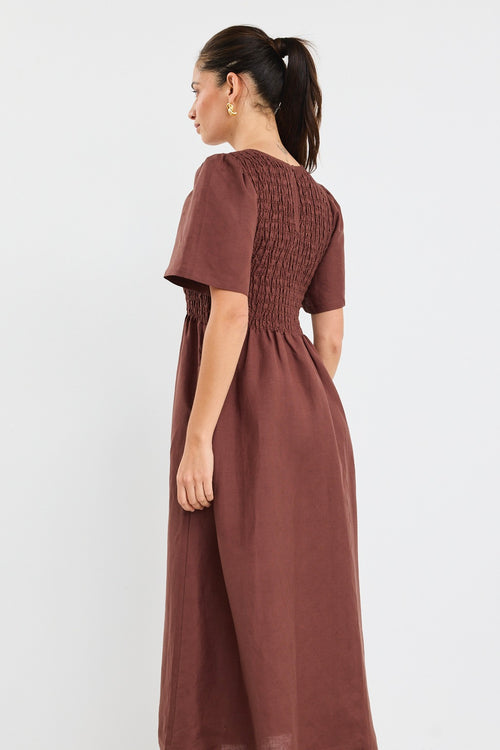 Model wears brown midi dress with a shirred cotton bodice and short sleeves