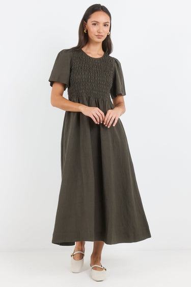 Woman wearing a green dress on a white background
