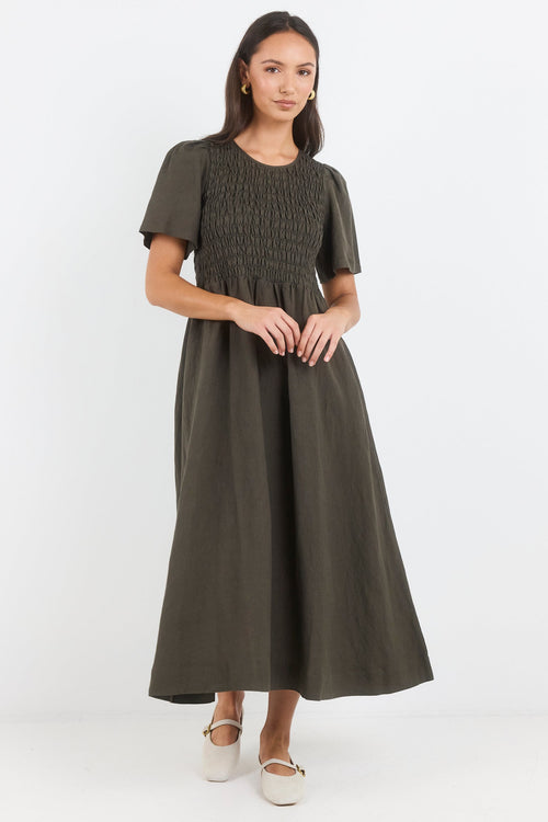 Woman wearing a green dress on a white background