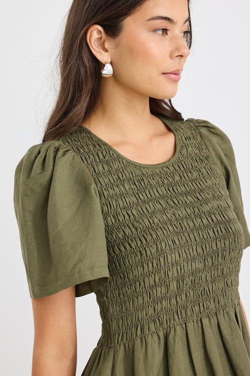 model wears a khaki linen midi dress